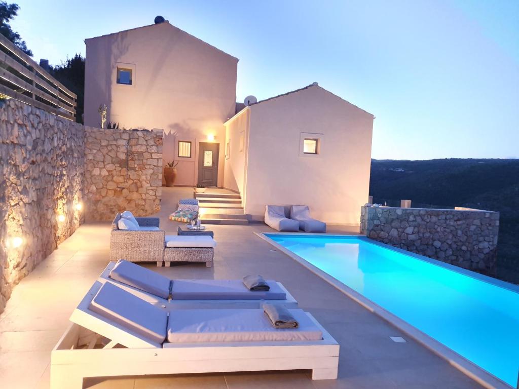 a backyard with a swimming pool and a villa at Villa Albatross in Sivota