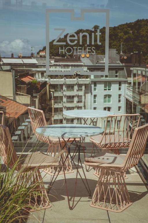 a table and chairs on the roof of a building at Zenit Convento San Martin in San Sebastián