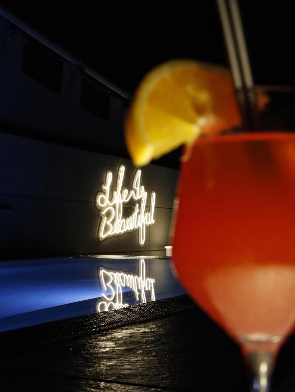 a drink with a lemon in front of a sign at Zenit Convento San Martin in San Sebastián