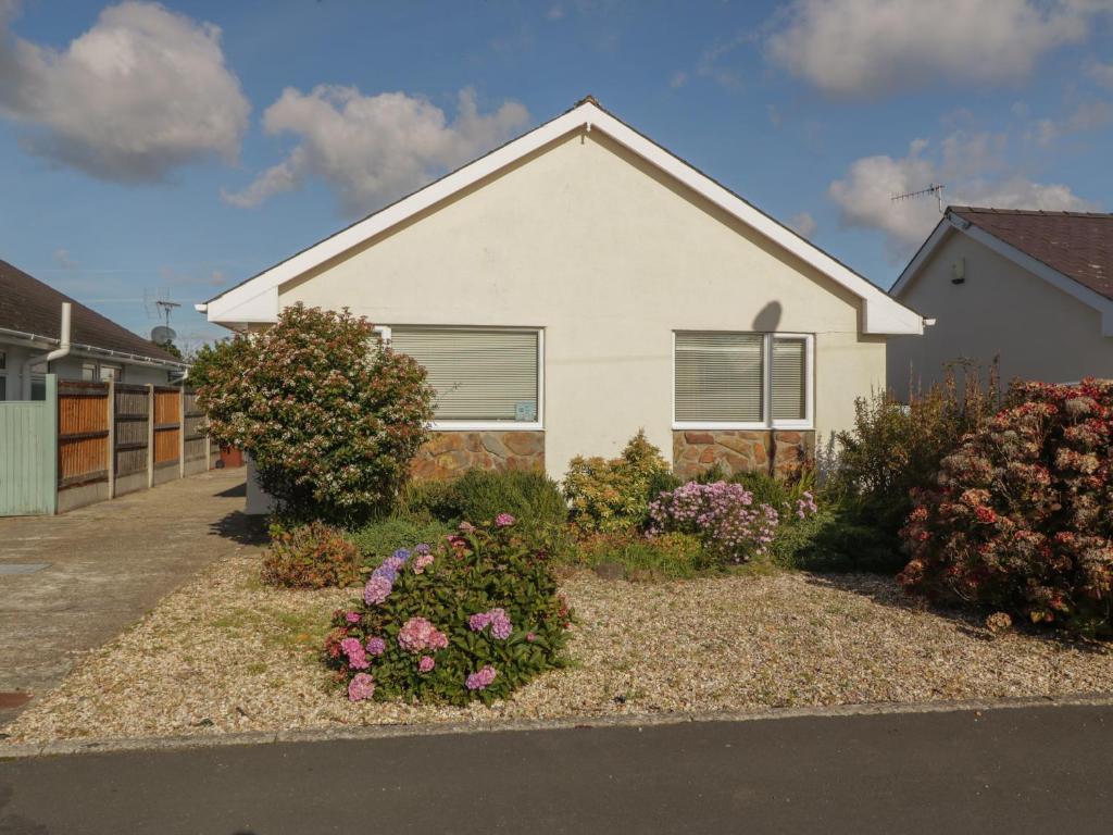 a house with some flowers in front of it at Seaside retreat in Porthmadog