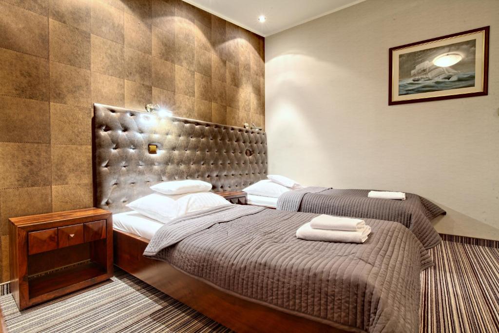 Postel nebo postele na pokoji v ubytování Hotel Rejs