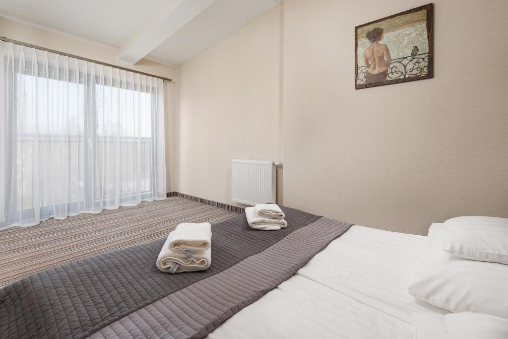Postel nebo postele na pokoji v ubytování Hotel Rejs