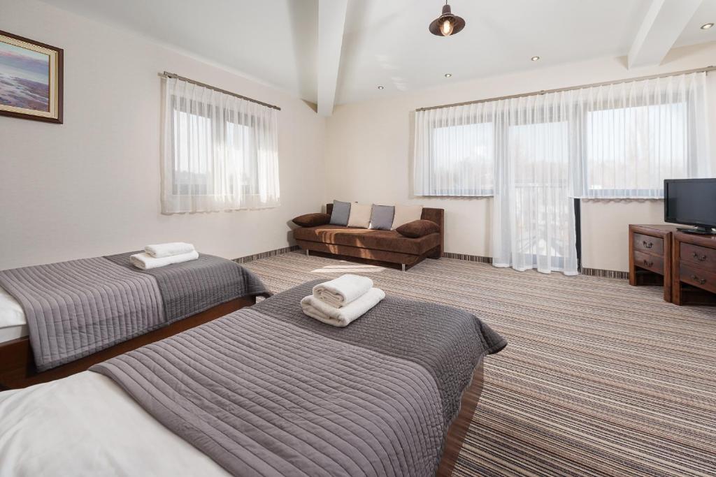 Postel nebo postele na pokoji v ubytování Hotel Rejs
