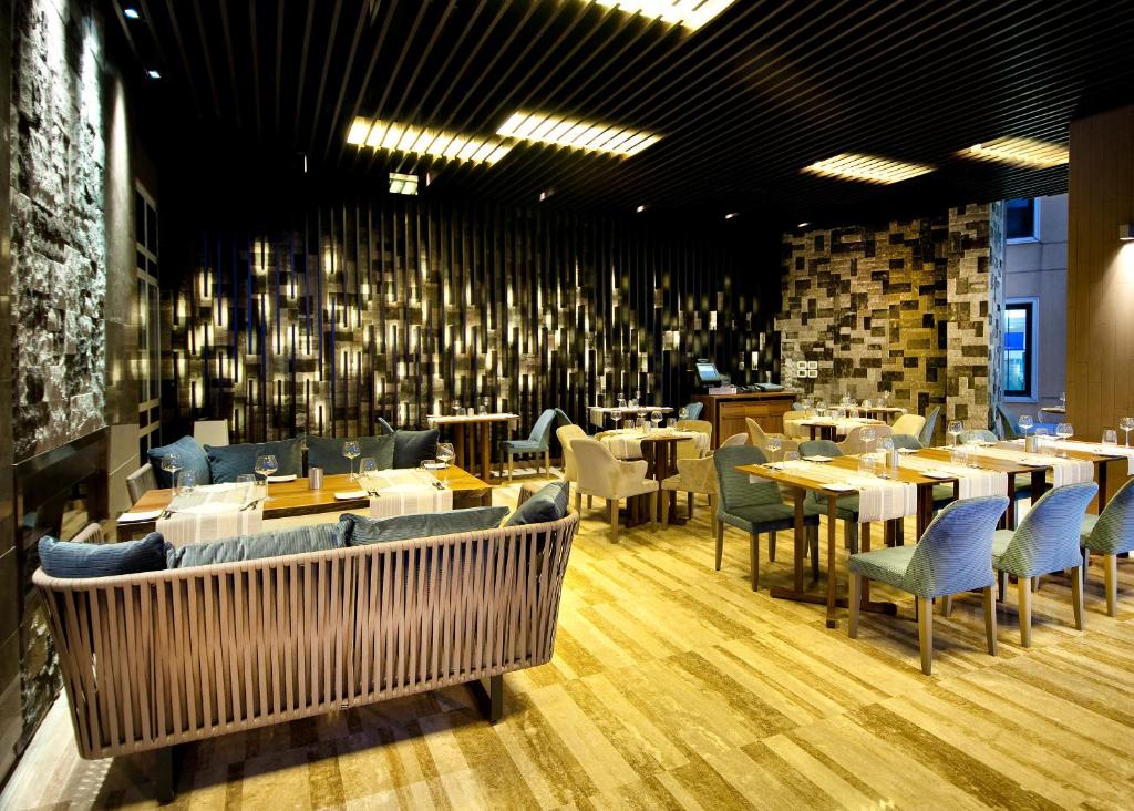 a restaurant with tables and chairs in a room at The Marmara Taksim in Istanbul