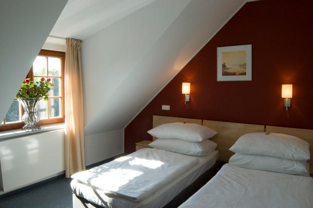Postel nebo postele na pokoji v ubytování Hotel Chvalská Tvrz
