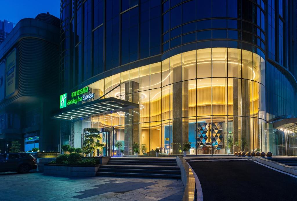a large glass building with stairs in front of it at Holiday Inn Express Changsha Wuyi Plaza , an IHG Hotel in Changsha