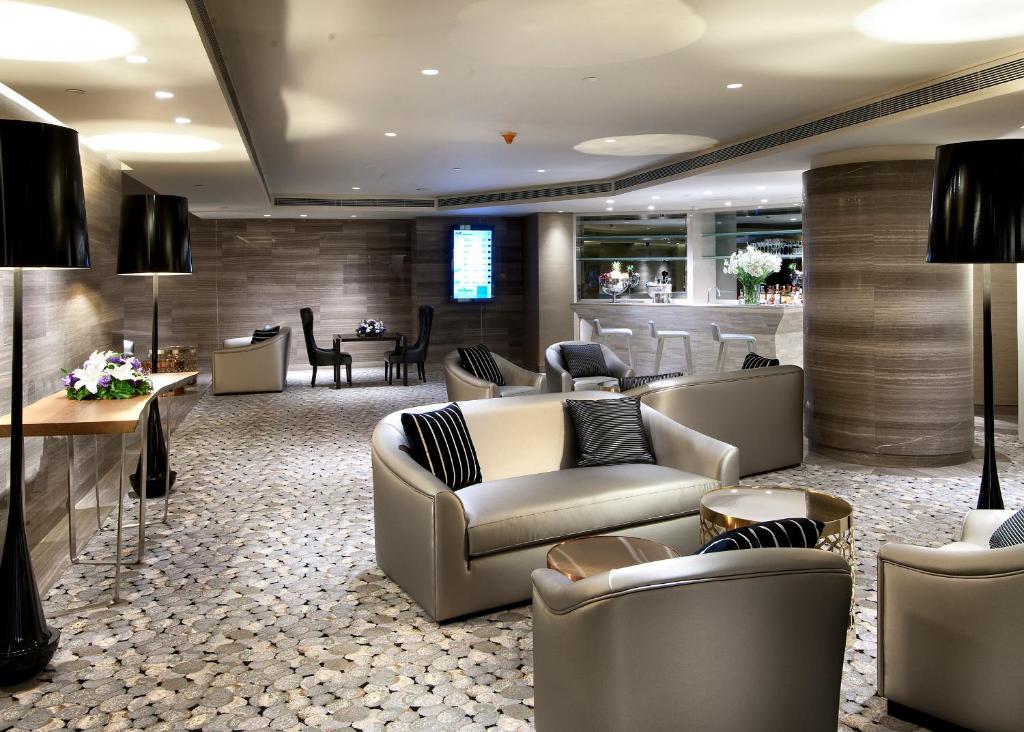 a lobby with couches and tables and a bar at The Marmara Taksim in Istanbul