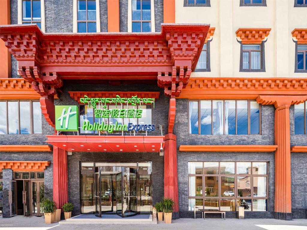 a building with a sign on the front of it at Holiday Inn Express Litang by IHG in Lithang