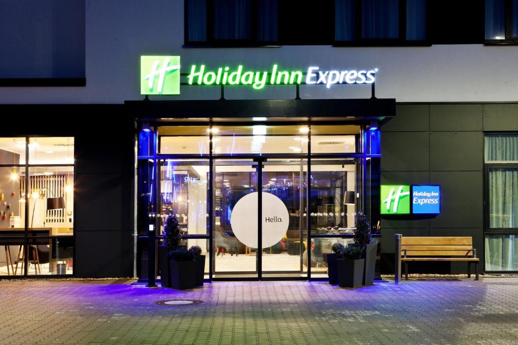 uma frente de loja com uma placa que lê Holiday Inn Express em Holiday Inn Express - Kaiserslautern, an IHG Hotel em Kaiserslautern