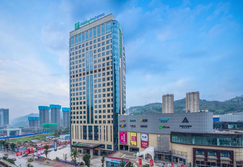 un edificio alto en medio de una ciudad en Holiday Inn Express Chongqing Zhongxian by IHG, en Zhongzhou