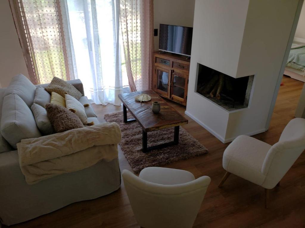a living room with a couch and a fireplace at Al Nair Casa de playa RESERVA CON SEÑA in La Pedrera