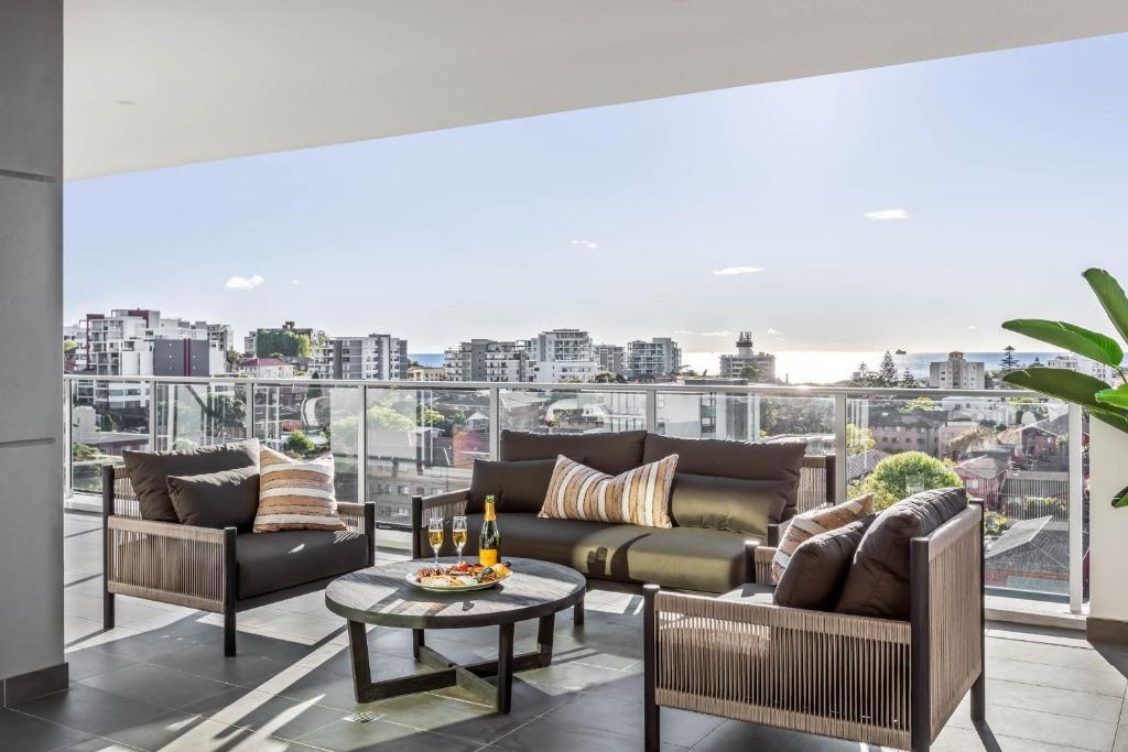 a living room with a couch and a table at Argo Apartments in Wollongong