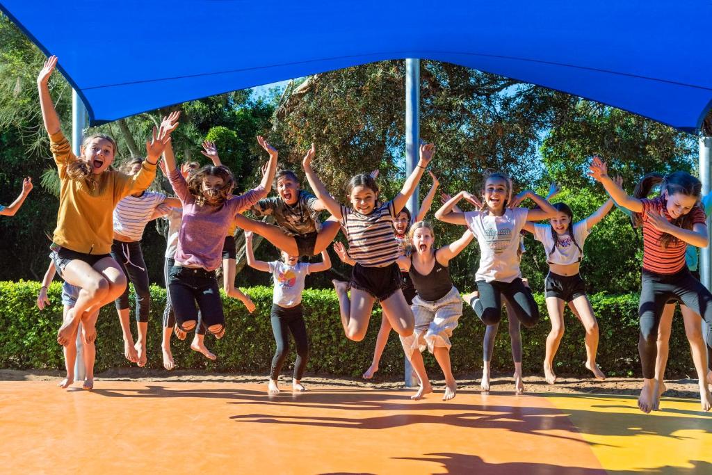 a group of people jumping on a trampoline at Discovery Parks - Emerald Beach in Emerald Beach