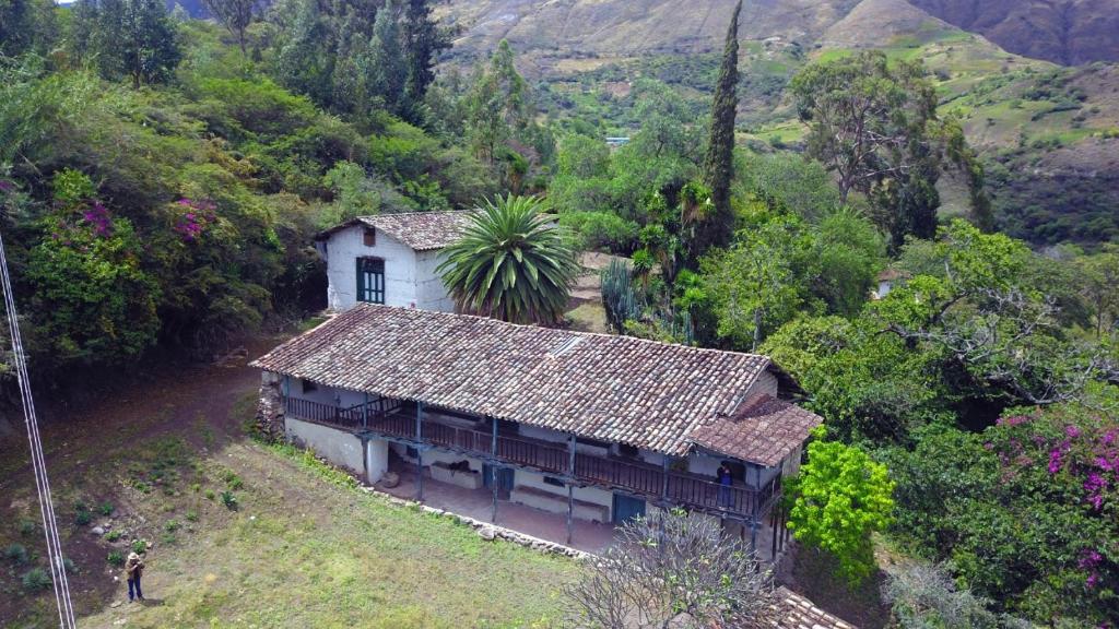 a small house in the middle of a mountain at Hacienda Gonzabal in Loja