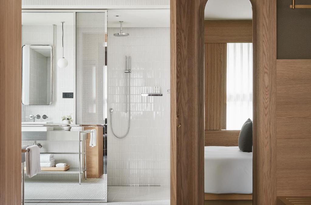 a bathroom with a shower and a sink at Kimpton Da An Taipei- an IHG Hotel in Taipei
