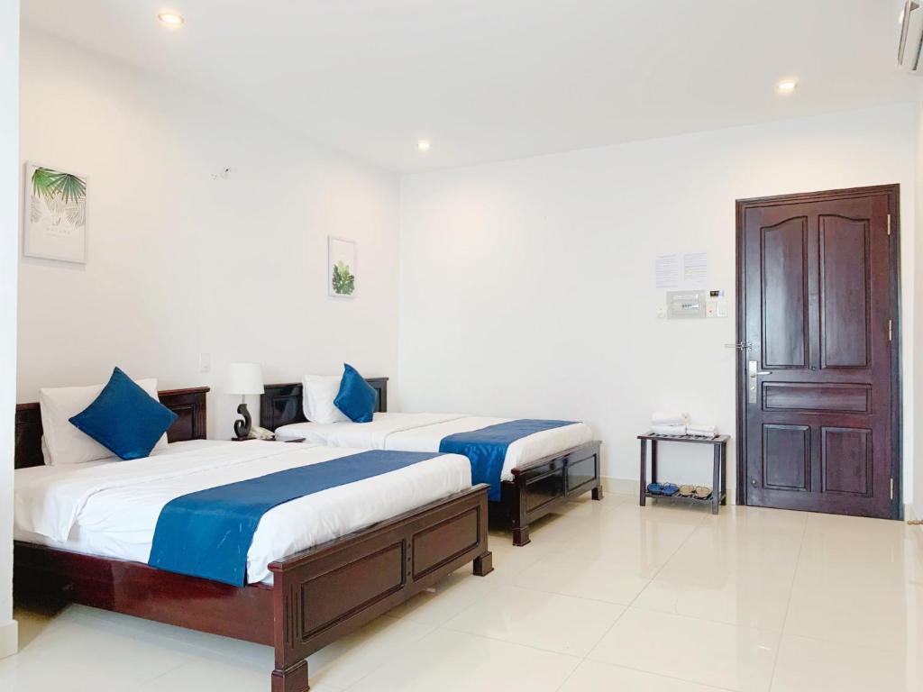 Postel nebo postele na pokoji v ubytování Tehana Beach Hotel Da Nang