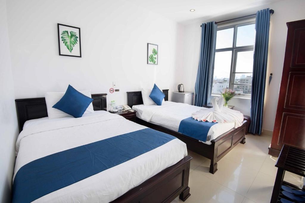 Postel nebo postele na pokoji v ubytování Tehana Beach Hotel Da Nang