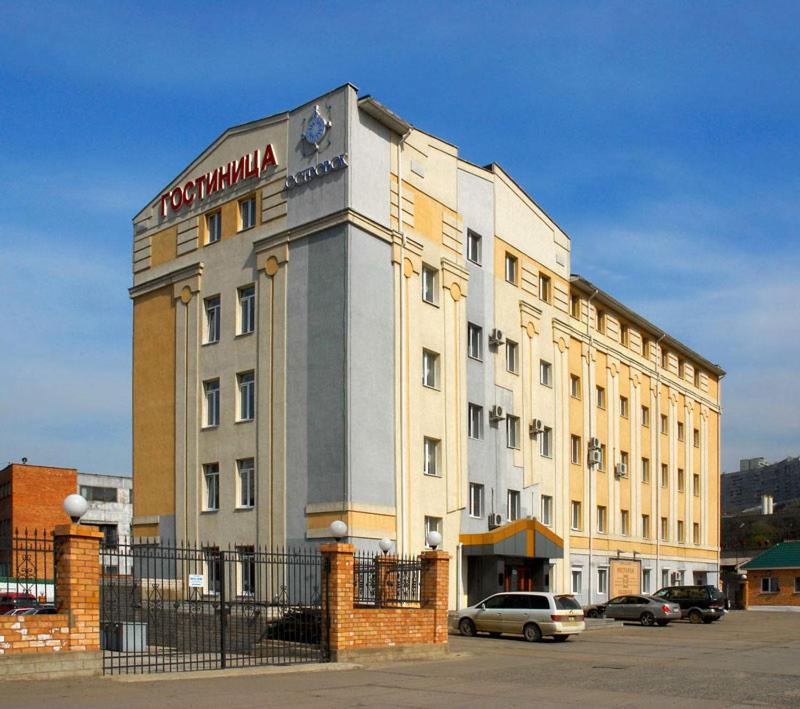 a building with a sign on the side of it at Ostrovok in Vladivostok