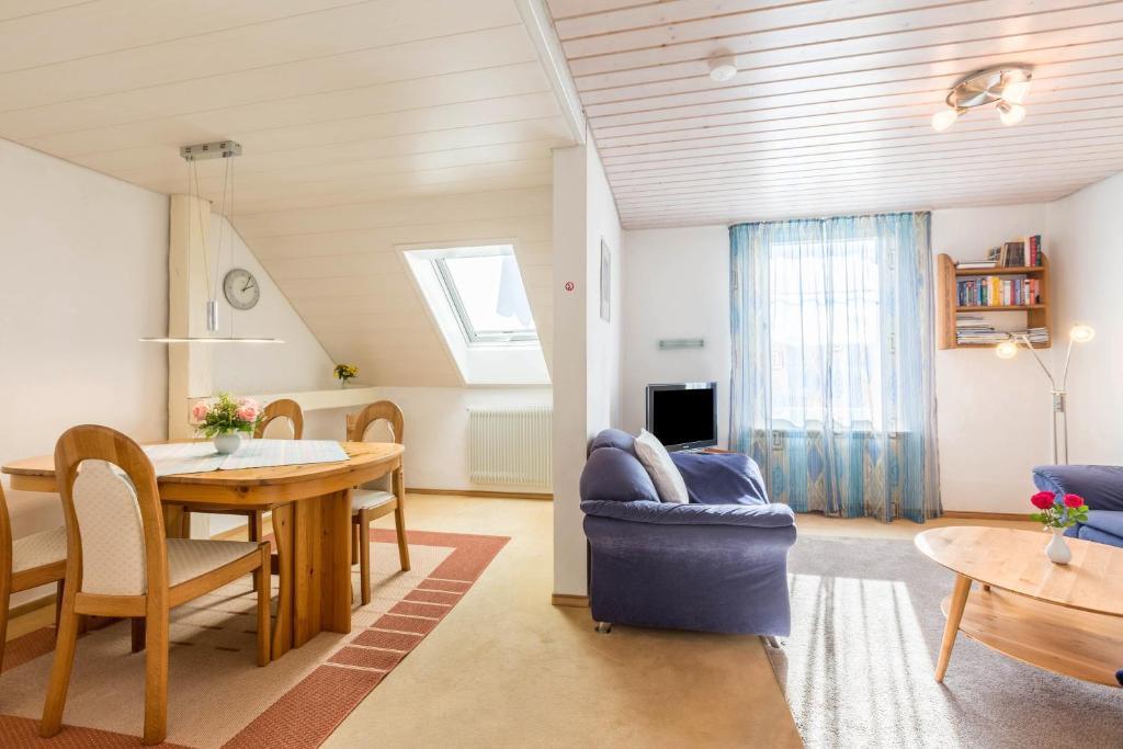 a living room and dining room with a table and chairs at Ferienwohnung zum Seeblick in Öhningen