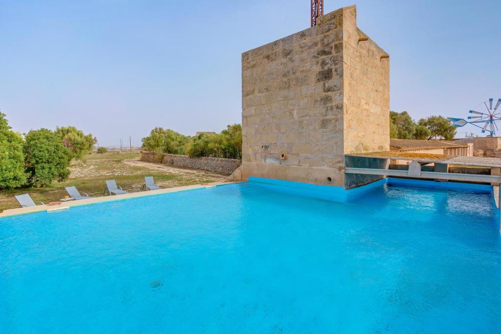 The swimming pool at or close to Possessio Sa Barrala Gallinero