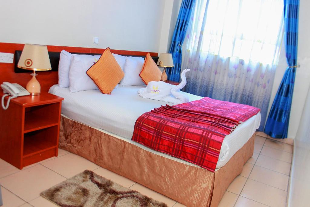 Postel nebo postele na pokoji v ubytování Sheratton Regency Hotel Nairobi
