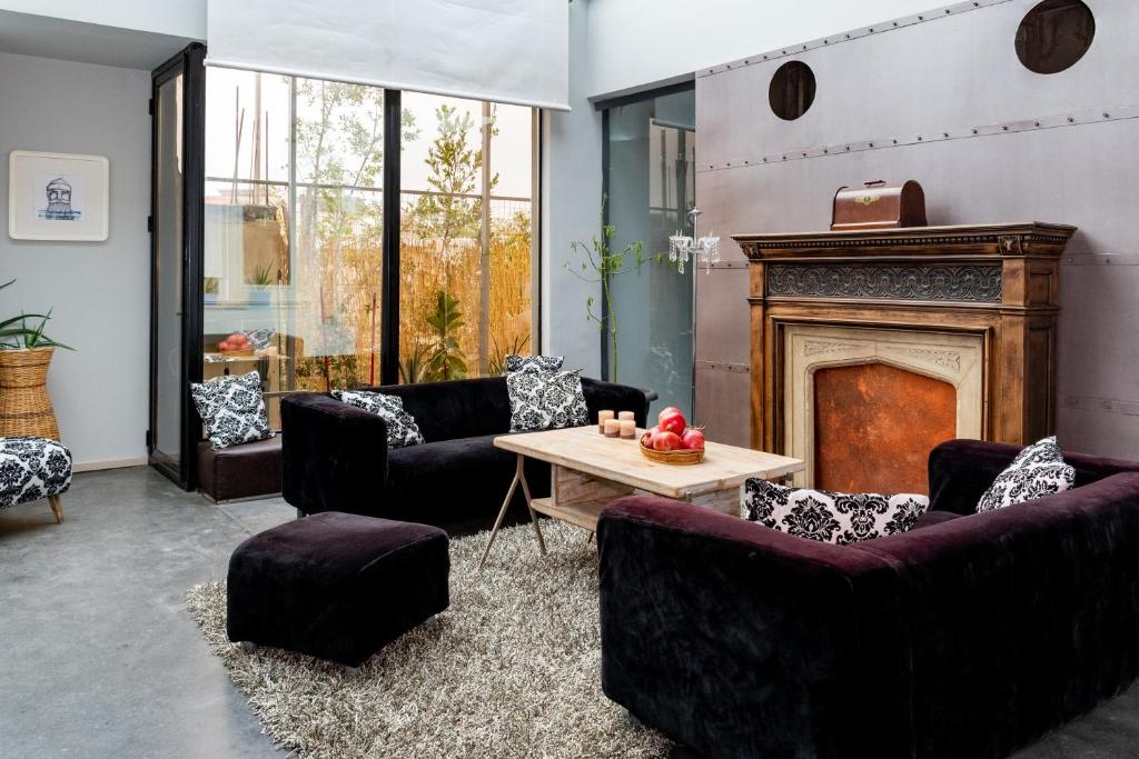 a living room with couches and a fireplace at Sinanis city home in Volos