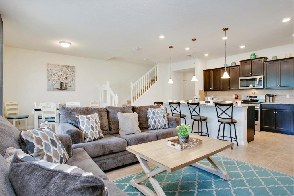 a living room and kitchen with a couch and a table at Townhome wPrivate Pool & FREE Water Park in Davenport