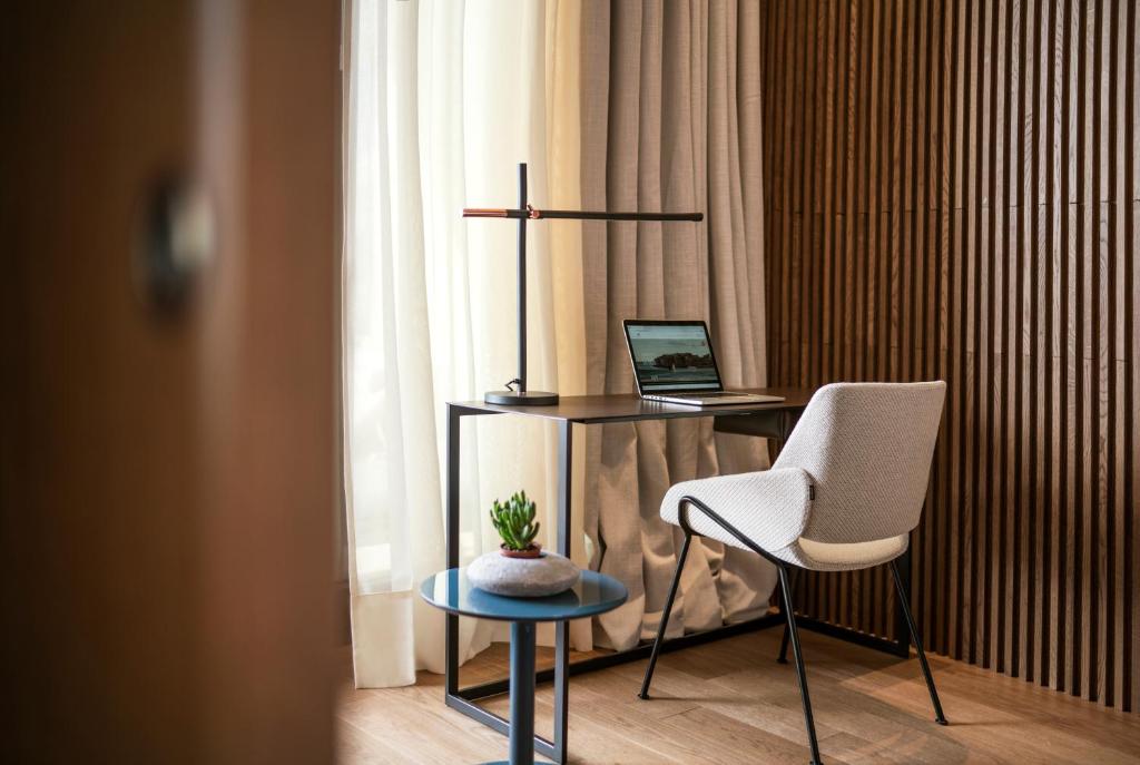 a desk with a laptop and a chair in a room at Hotel Dubrovnik Palace in Dubrovnik