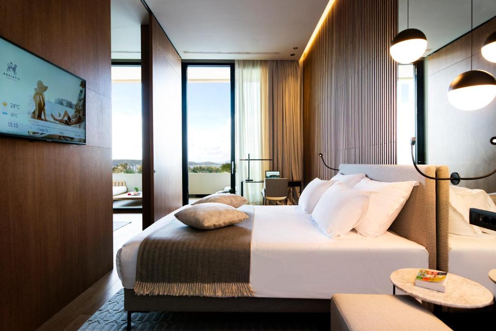 a hotel room with a bed and a large window at Hotel Dubrovnik Palace in Dubrovnik