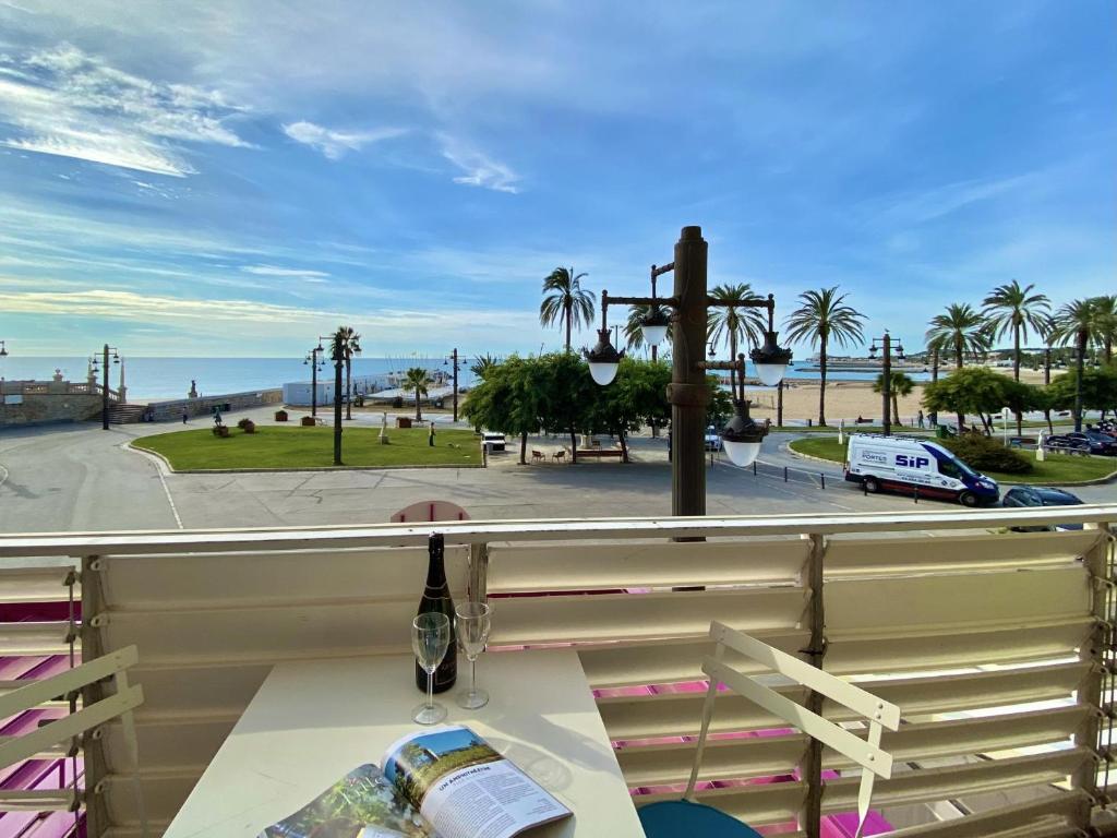 
a park bench sitting on top of a sidewalk at Casa del mar in Sitges
