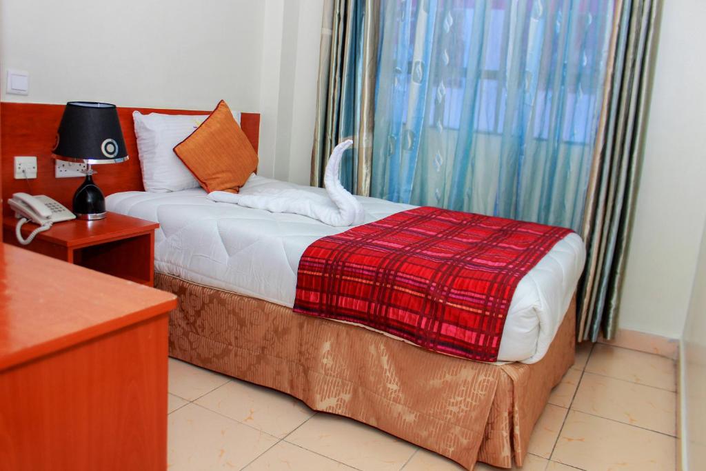 Postel nebo postele na pokoji v ubytování Sheratton Regency Hotel Nairobi