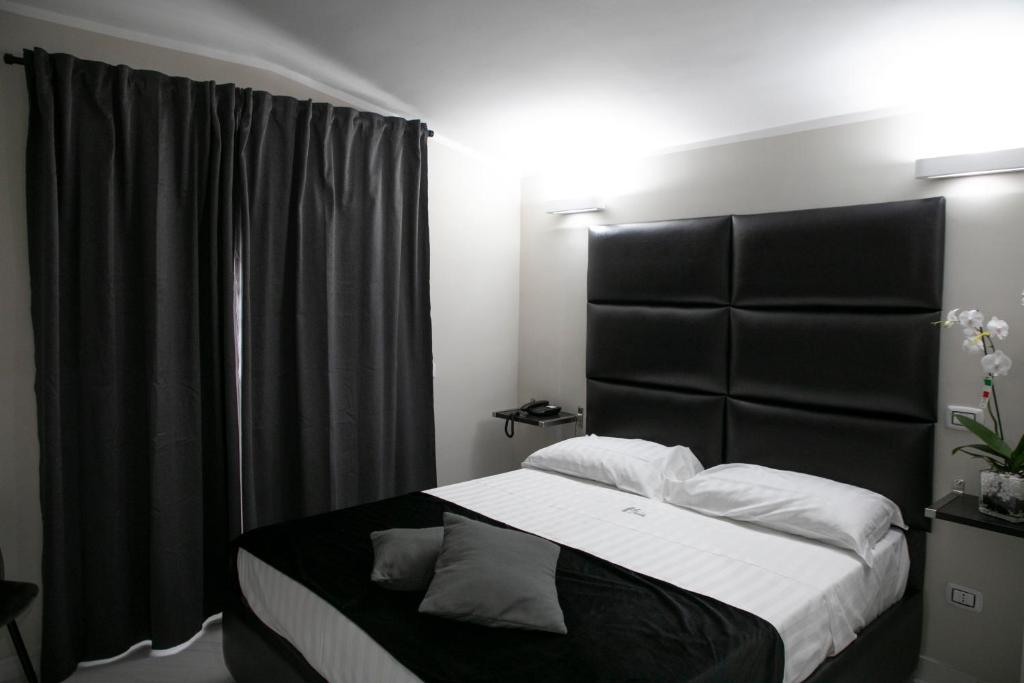 Postel nebo postele na pokoji v ubytování Hotel Trionfal