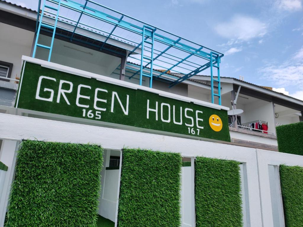 a green house sign on the side of a building at Lake Residence No165 @aesthetic lake view & best photograph in Puchong
