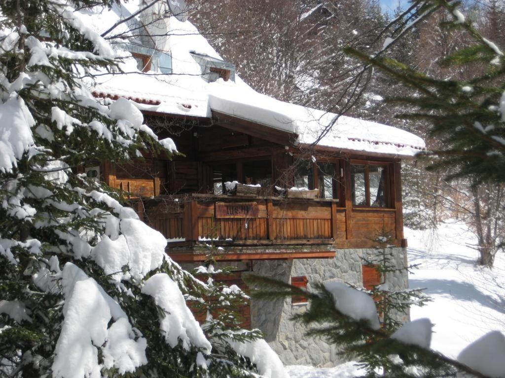 a wooden cabin with snow on top of it at Guesthouse Šejn in Kopaonik