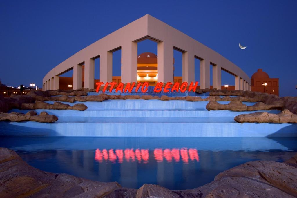 a building with a sign that reads thanks be back at Titanic Beach - Families and Couples only in Hurghada