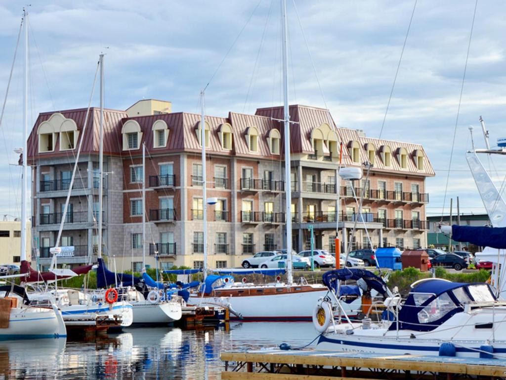 a group of boats docked in front of a building at Château Arnaud in Sept-Îles