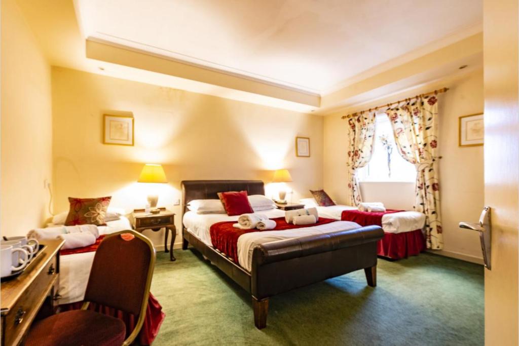Ein Bett oder Betten in einem Zimmer der Unterkunft OYO Paddington House Hotel