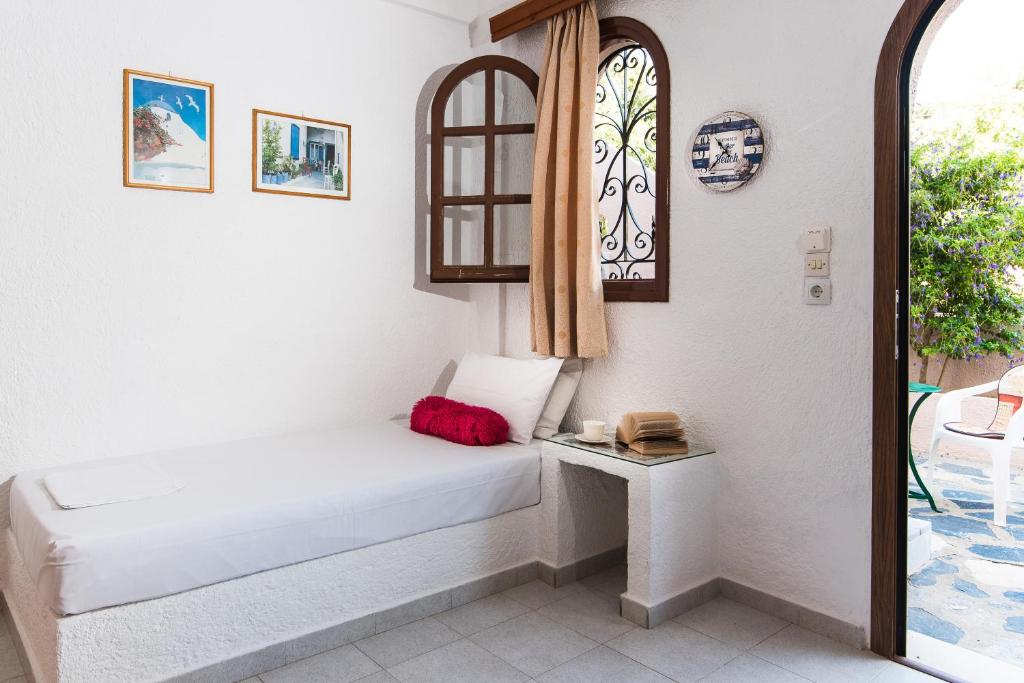 a small room with a bed and a window at Olondio Apartments in Elounda