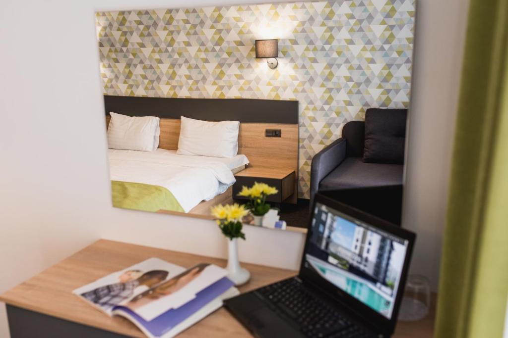 Postel nebo postele na pokoji v ubytování Arena Apart - Hotel