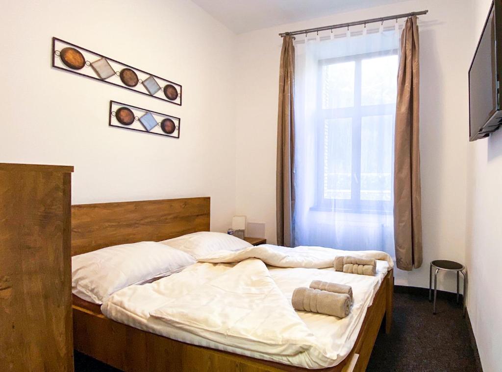 a bedroom with two beds and a window at Hotel Sýkora in Křivoklát