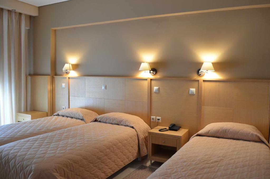 Postel nebo postele na pokoji v ubytování Evia Hotel & Suites