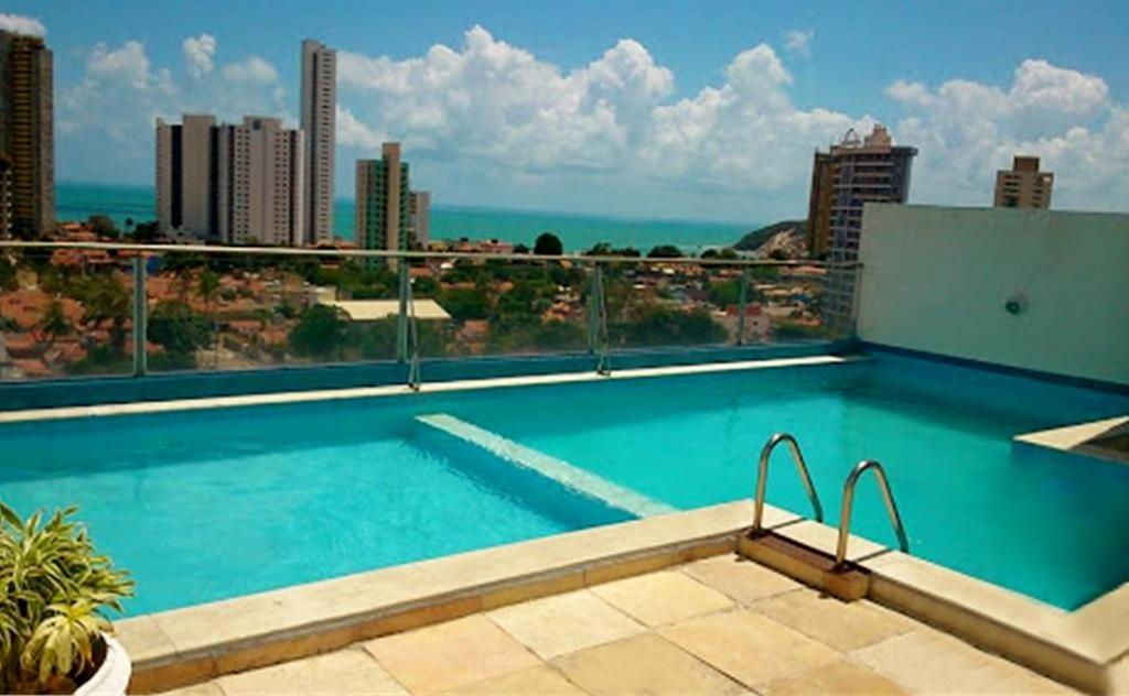 a swimming pool on the roof of a building at Ana marinho flat 702 in Natal
