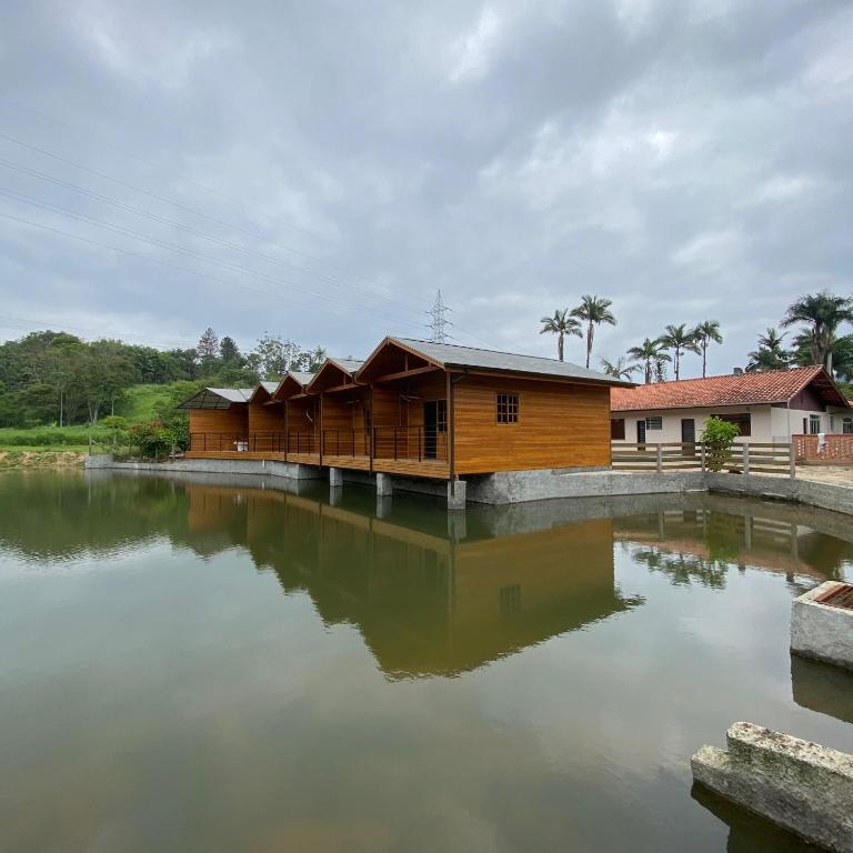a building with water in front of it at Pousada Recanto Pomerano in Pomerode