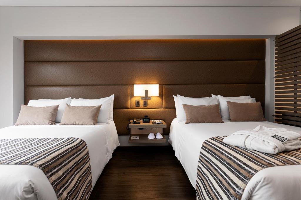 Postel nebo postele na pokoji v ubytování bs Rosales Hotel