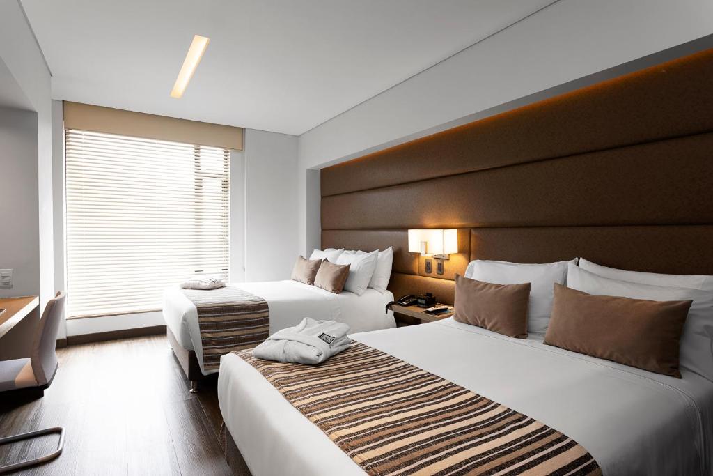 Postel nebo postele na pokoji v ubytování bs Rosales Hotel