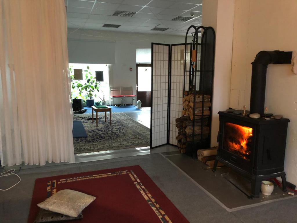 a living room with a wood stove in a room at Stuudio in Viljandi