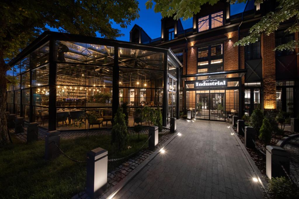 a building with a lit up patio at night at Industrial 1853. in Kragujevac