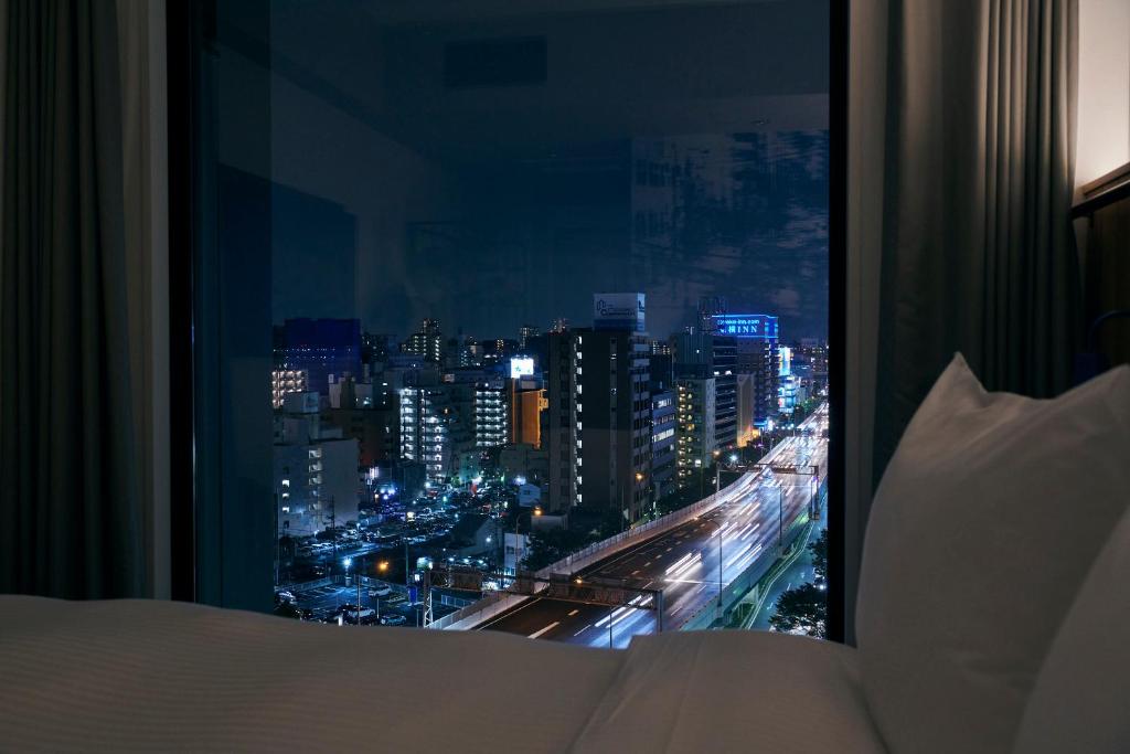 Postel nebo postele na pokoji v ubytování ibis Styles Nagoya