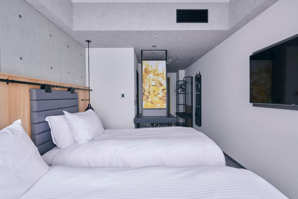Postel nebo postele na pokoji v ubytování ibis Styles Nagoya