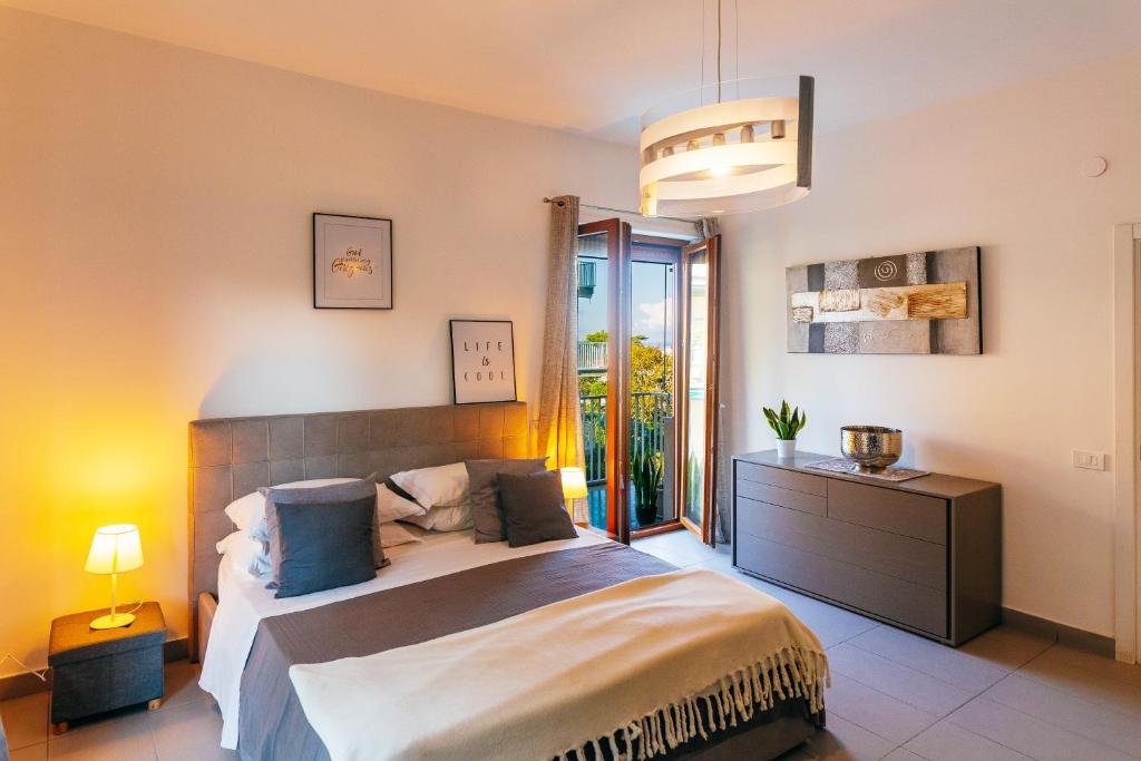 a bedroom with a large bed and a pendant light at Sorrento City Apartment in Sorrento